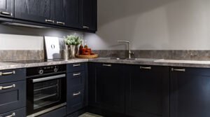 Dark kitchen cabinets with metal pulls or knobs in home interior.