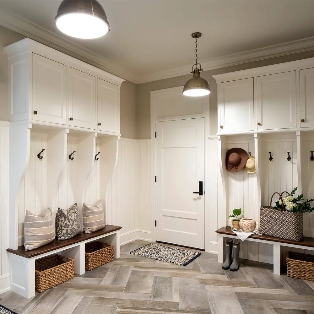 White mudroom storage with cubbies, hooks, and a bench